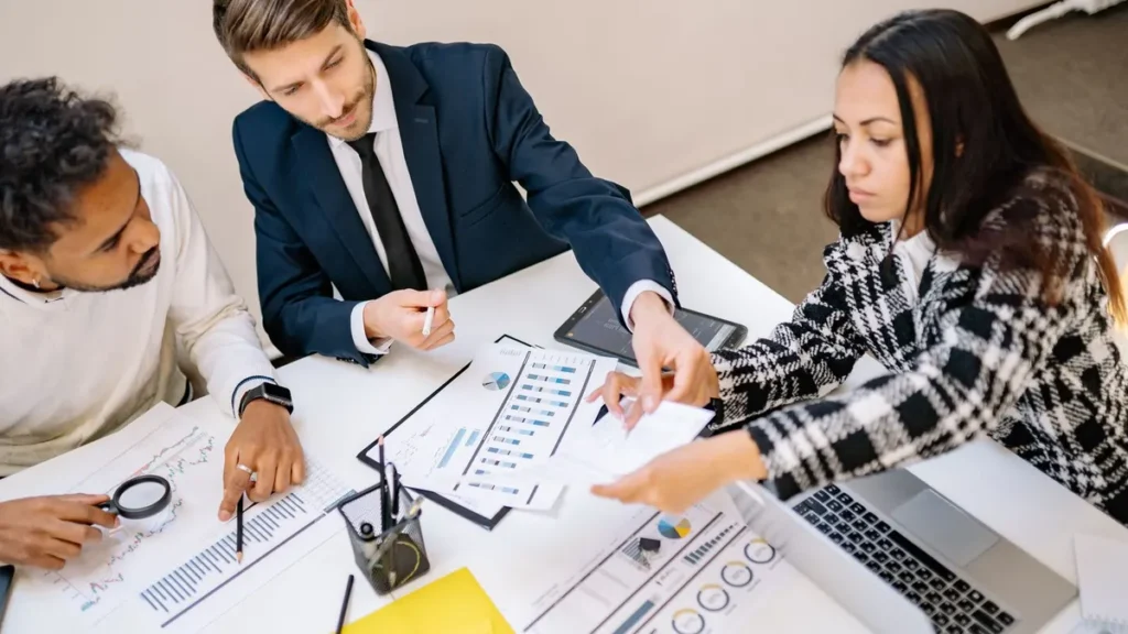Business team reviewing a garment development brief at a table