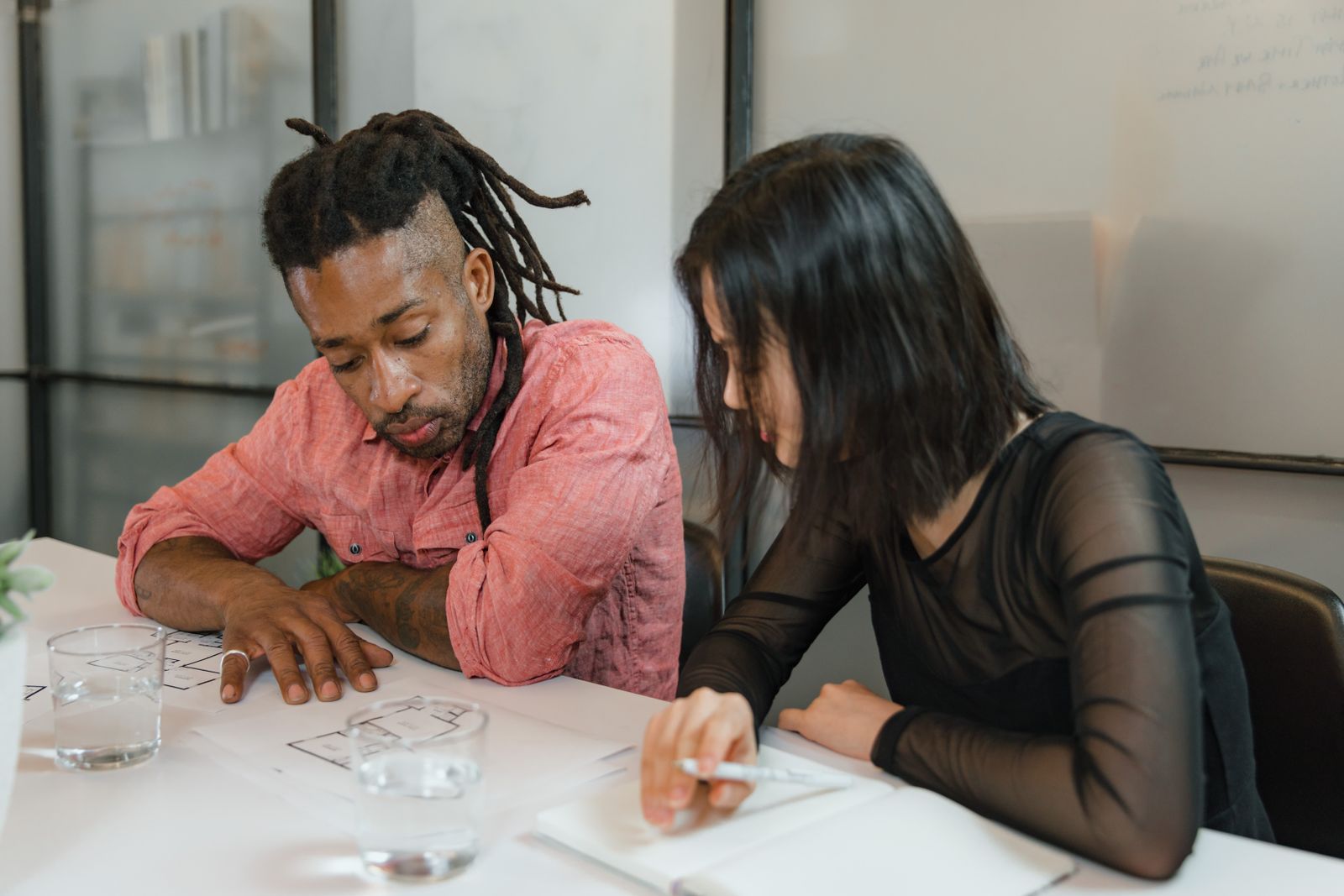 Product team reviewing garment sketches and specification details before sampling