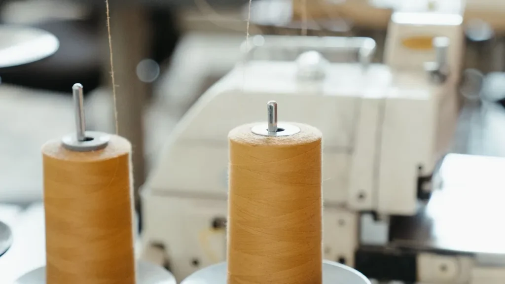 Sewing machine, thread and fabric used to review garment construction