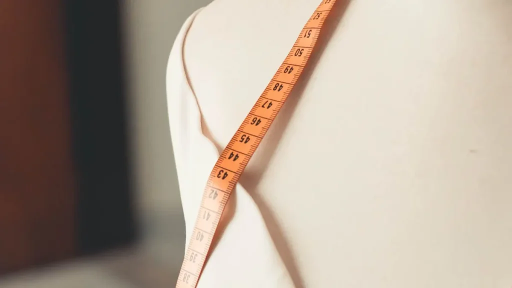 Measuring tape positioned on a dress form for a garment check