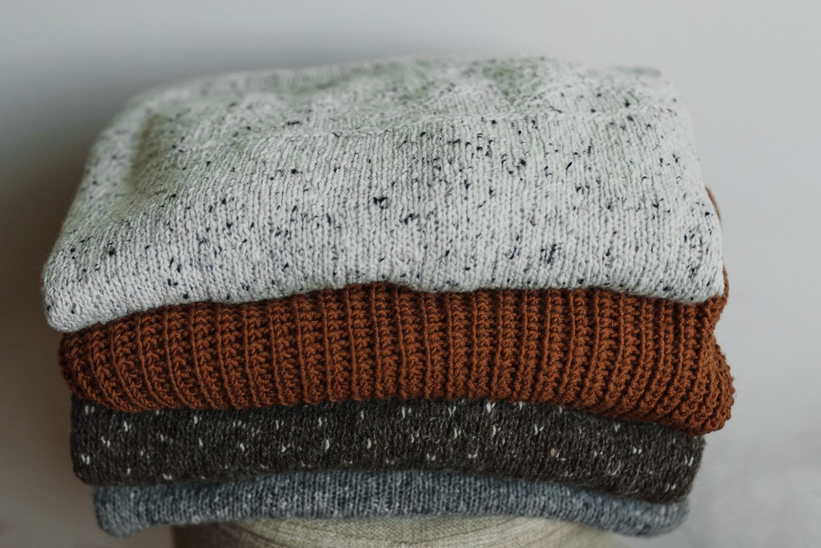 Neatly folded knit garments in a stack