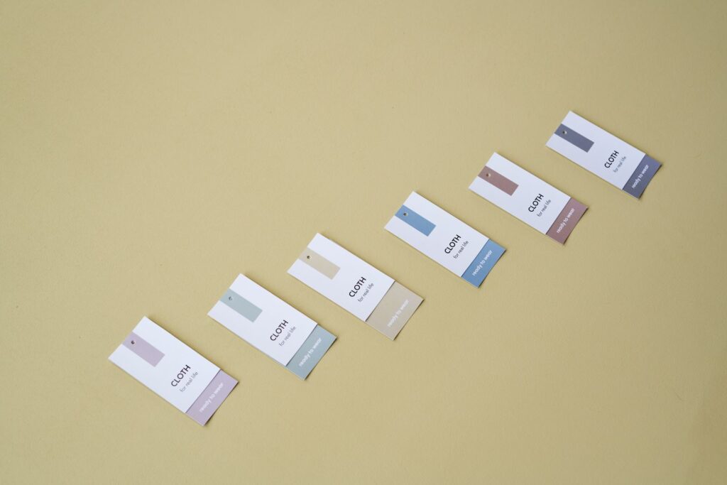 Minimal clothing hangtags arranged on a warm background