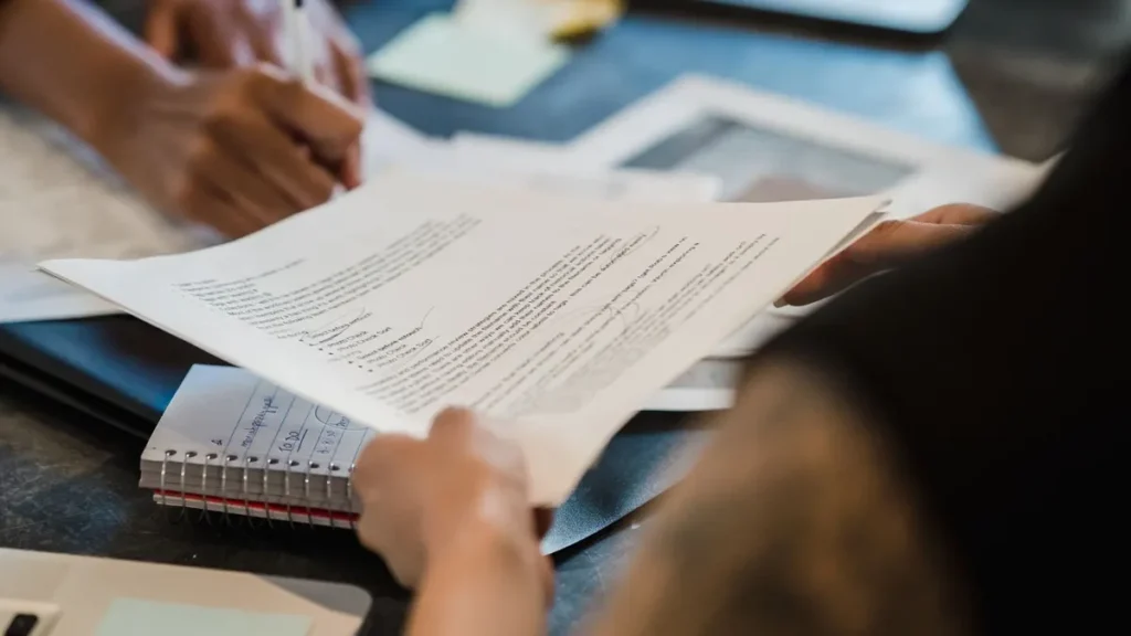 Business buyers reviewing and signing supplier quotation documents
